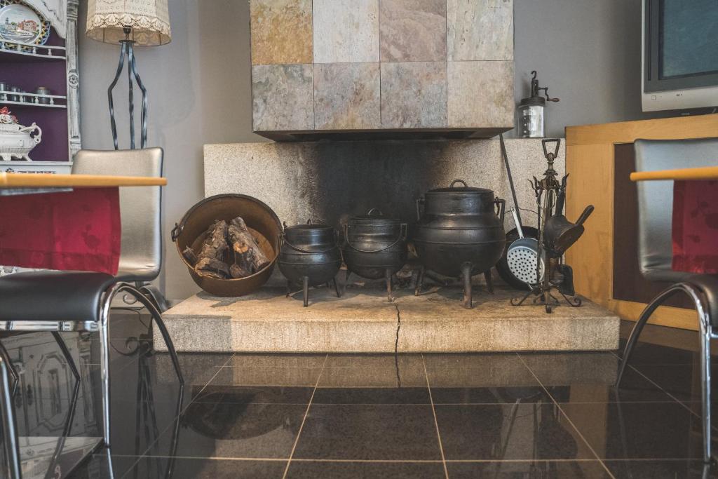 a kitchen with pots and pans on a fireplace at Hotel De Cerva in Cerva