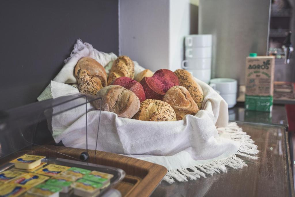 a tray of breads in a basket on a table at Hotel De Cerva in Cerva