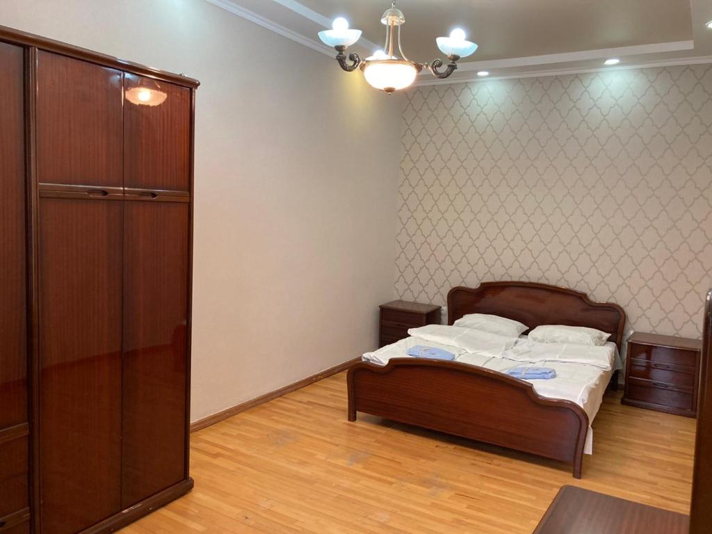 a bedroom with a bed and a closet in it at House NAG in Kutaisi