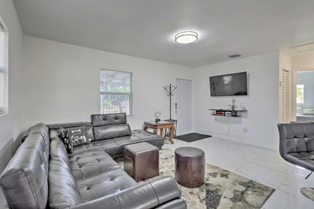 a living room with a leather couch and a tv at Pet-Friendly Miami House about 8 Mi to Beaches! in Miami