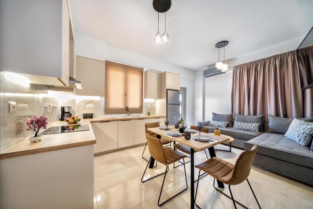 a kitchen and a living room with a table and chairs at Seaside Apartments in Hersonissos