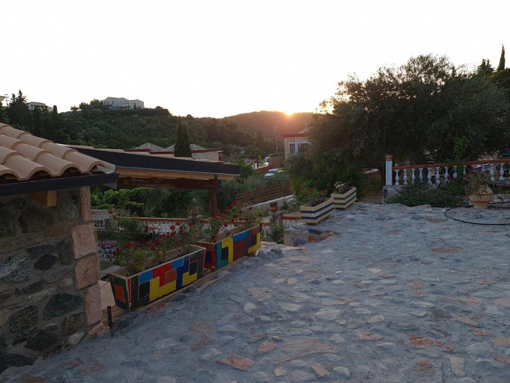a garden with colorful flowers and a building at Edem Studios in Syvota