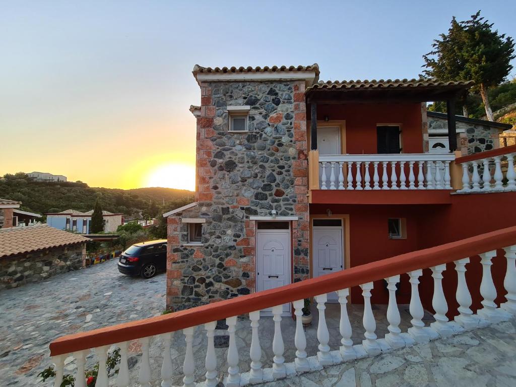a house with a sunset in the background at Edem Studios in Syvota