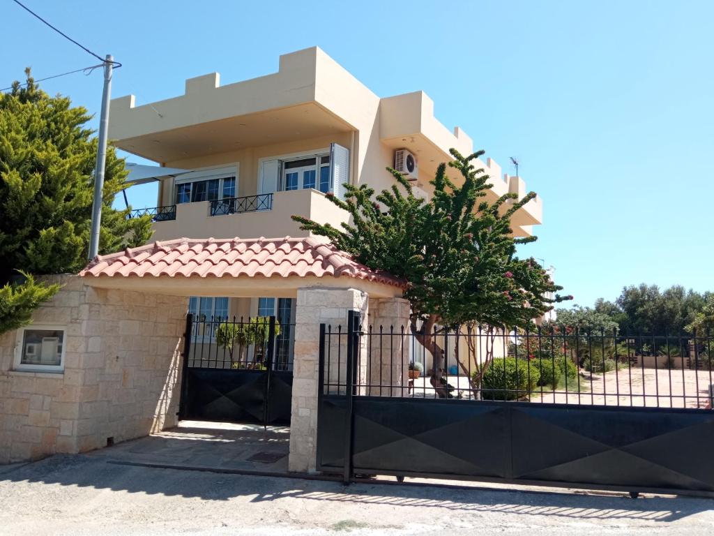 a house with a gate and a fence at Kallia's Sea View Home Suite in Hersonissos