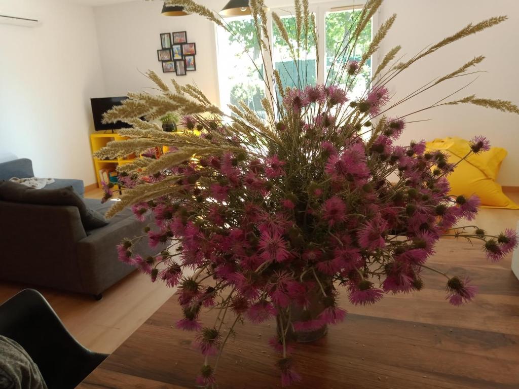 a vase filled with purple flowers on a table at Villa perpignanaise in Perpignan