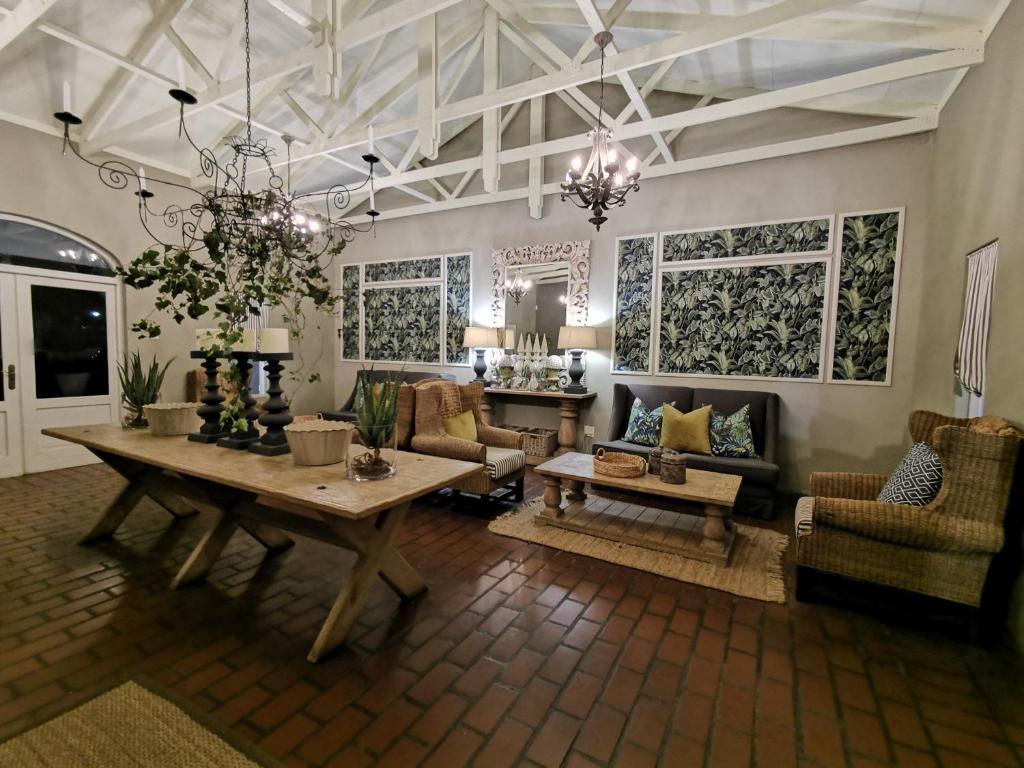 a living room with a wooden table and chairs at Pecan Manor in Hartbeespoort