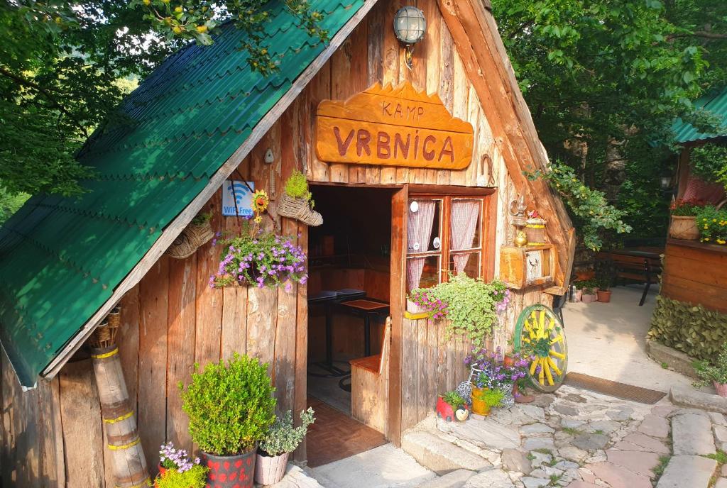 a wooden play house with a sign on it at Kamp Vrbnica in Plužine