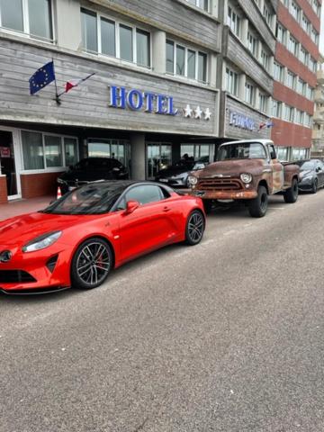 a red car parked in front of a hotel at Hotel de l&#39;Europe in Dieppe