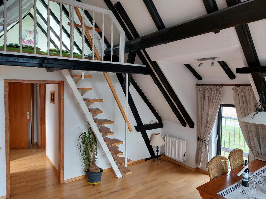 a living room with a spiral staircase in a loft at Haus Schaumburger Land in Volksdorf