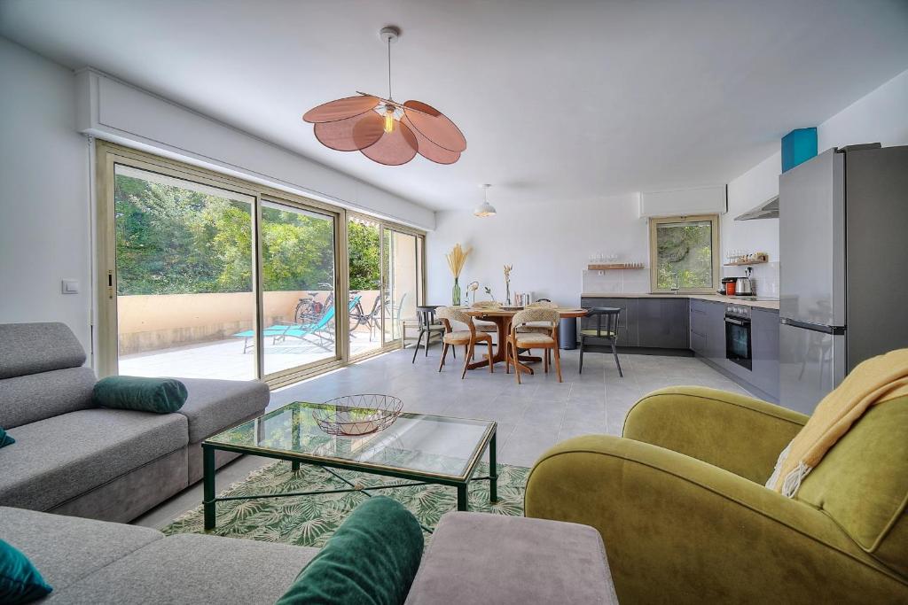 un salon avec un canapé et une table dans l'établissement IMMOGROOM -  Vue mer - Piscine - Terrasse - Parking - Au Calme, à Cannes