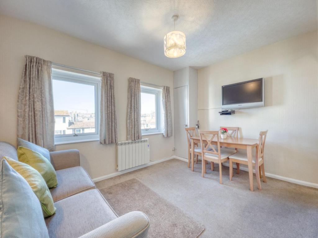 a living room with a couch and a dining room table at Apartment 3 - 2 Bedroom town views in Paignton