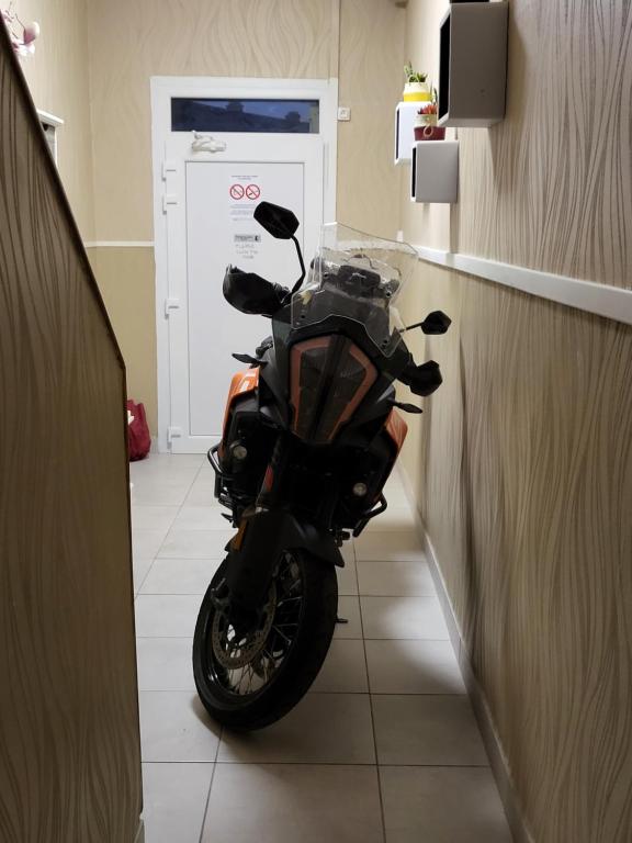 a motorcycle parked in a hallway in a room at Chambres privées Calais Ferry-Port-Place d&#39;armes in Calais