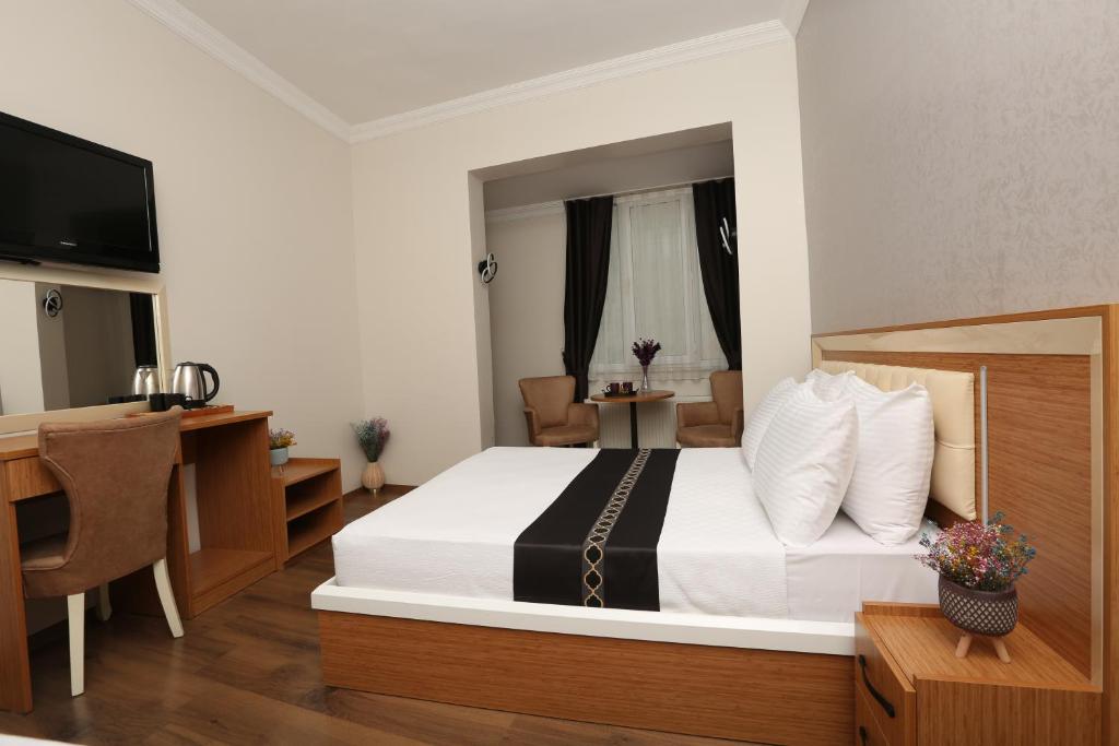 Säng eller sängar i ett rum på Perazre Hotel