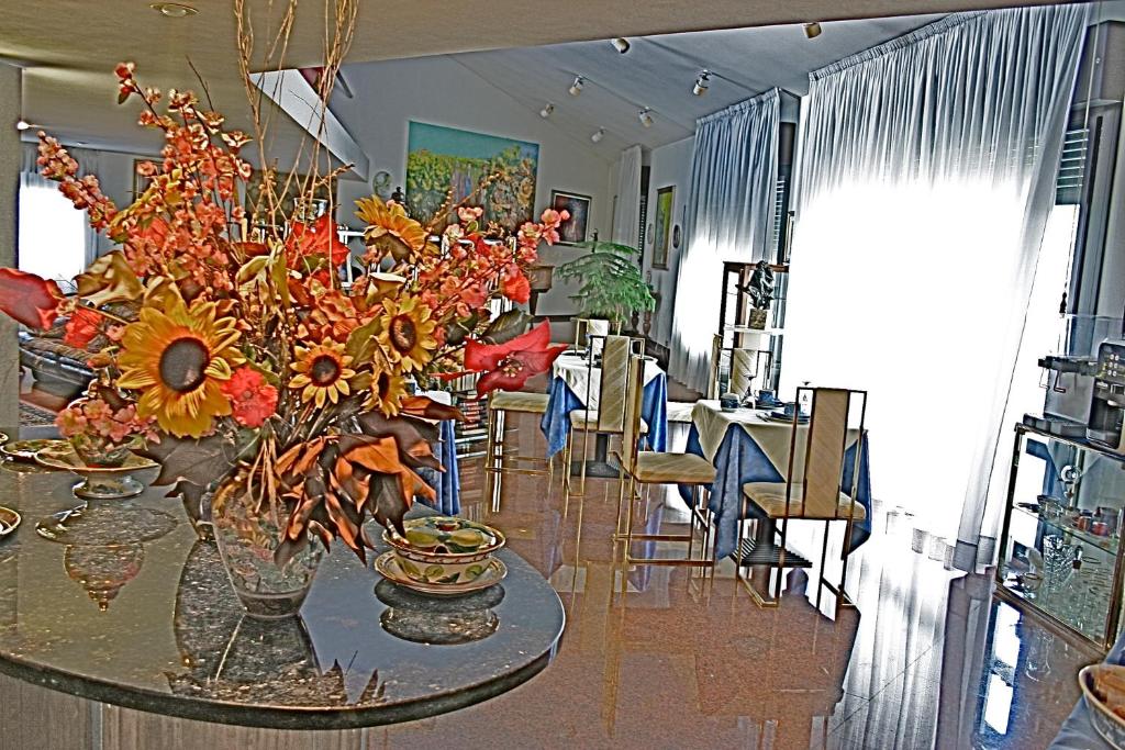 a vase with flowers on a table in a room at B&B Cà d'Artisti in Caorle