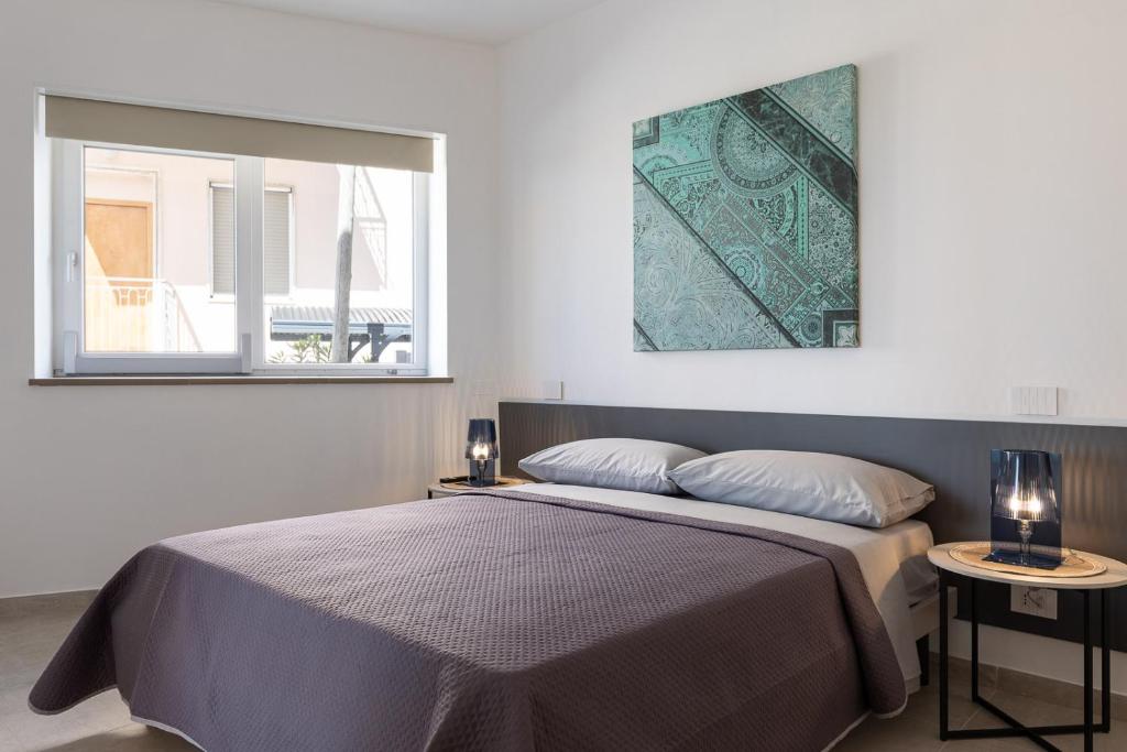 Posteľ alebo postele v izbe v ubytovaní Oneweek Gaeta Suites and Apartments