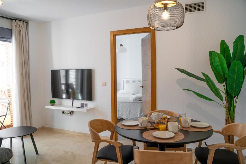 een eetkamer met een tafel en stoelen en een spiegel bij Apartamento Puerto Playa, Fuengirola centro in Fuengirola