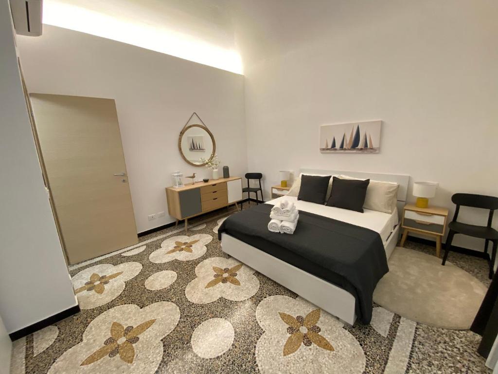 a bedroom with a bed and a table and chairs at Albatros in Savona
