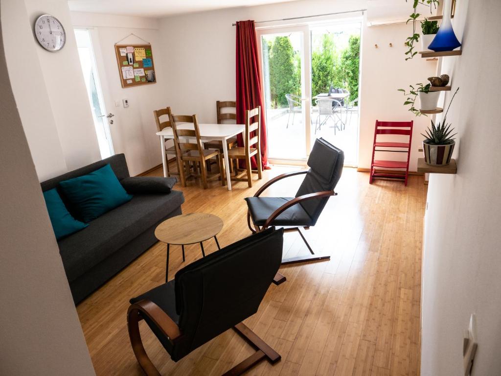 a living room with a couch and chairs and a table at D&N Apartment in Ljubljana