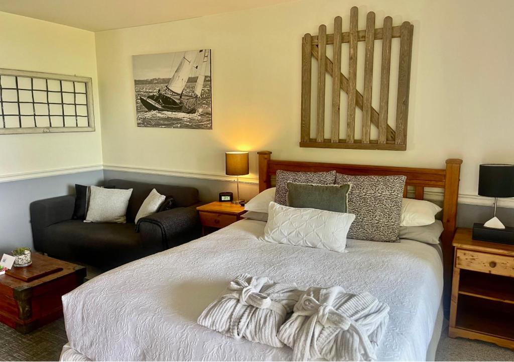 a bedroom with a large bed and a couch at Quarrystone House B&B in Fernwood