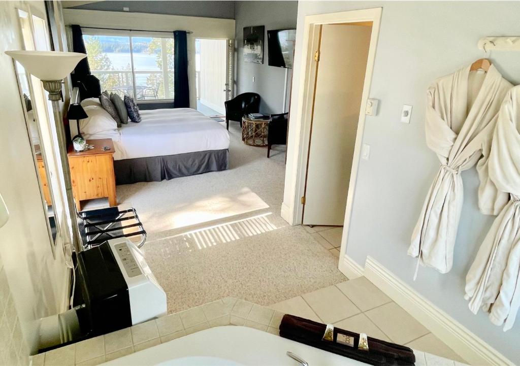 a bedroom with a bed and a bathroom with a sink at Quarrystone House B&B in Fernwood