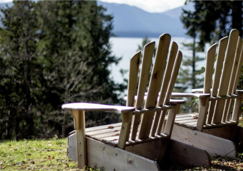 two wooden chairs sitting on top of a field at Quarrystone House B&B in Fernwood