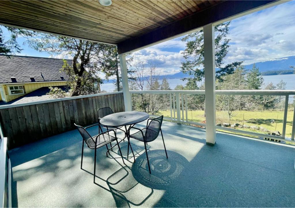 a balcony with a table and two chairs on it at Quarrystone House B&B in Fernwood
