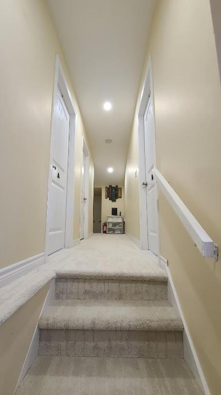 an empty hallway with two doors and stairs at Small Town Bound Inn in Montague