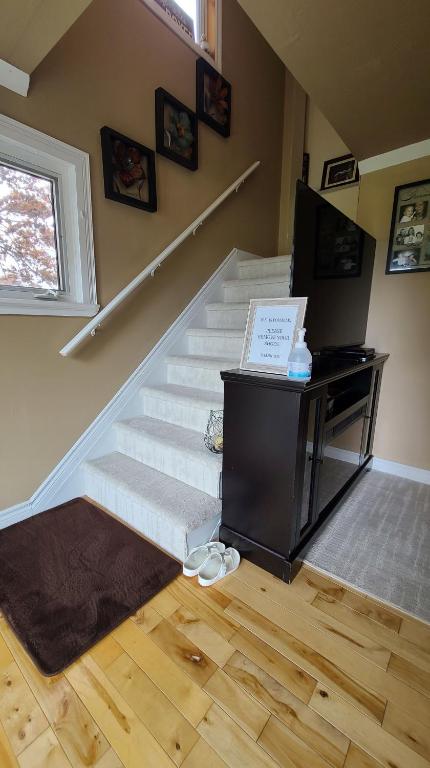 a room with stairs with a desk and a window at Small Town Bound Inn in Montague
