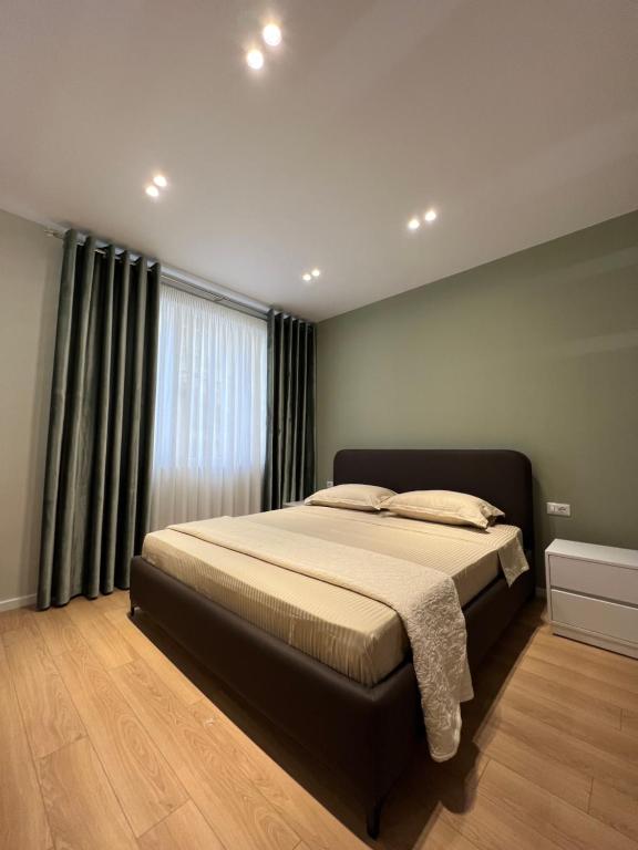 a bedroom with a bed and a large window at Costa Adriatica Apartments in Durrës