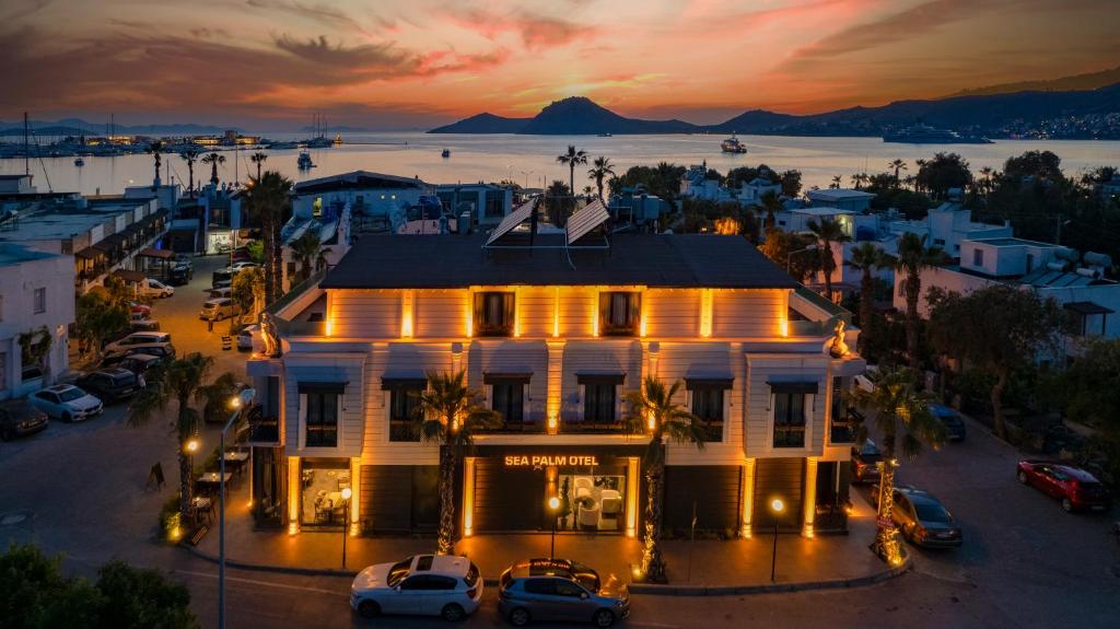 an aerial view of a building in a city at sunset at Sea Palm Otel Yalıkavak in Yalıkavak