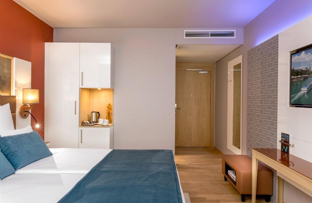 Postel nebo postele na pokoji v ubytování Leonardo Hotel Zurich Airport