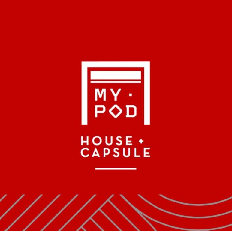 a red sign with the words my pod house capsule at My Pod House in Esquel