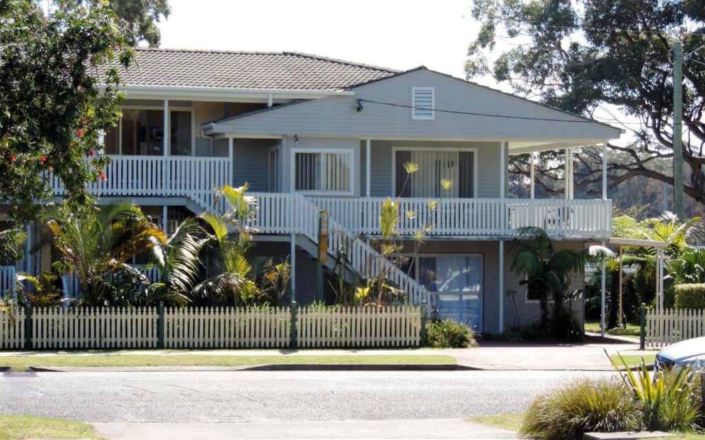 a house with a white fence in front of it at Sussex Shores in Sussex inlet