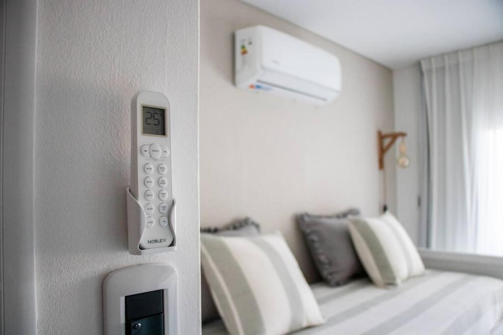 a remote control on a wall next to a bed at Sweet Dreams II in Junín