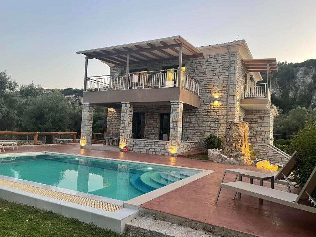 a house with a swimming pool in front of it at Iris Villas Complex in Lefkada Town