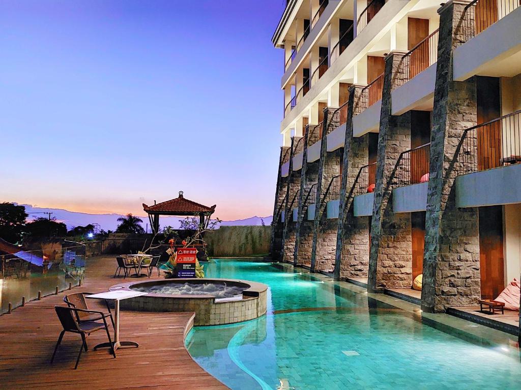 a swimming pool in the middle of a building at The Batu Hotel & Villas in Batu