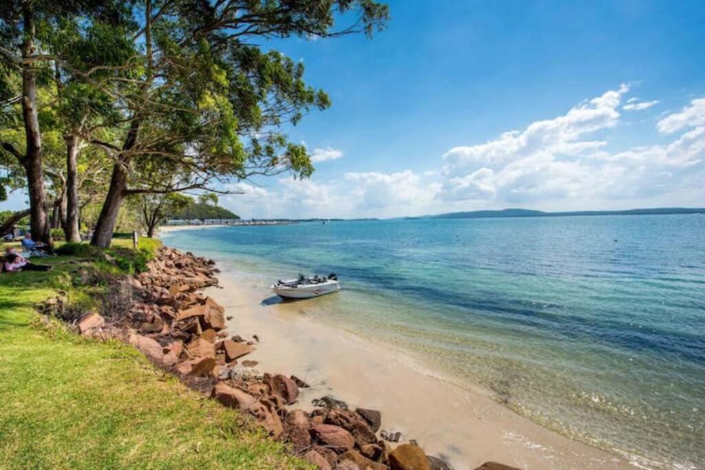 a boat in the water on a beach at Dolphin Shores in Corlette