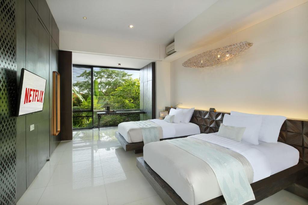 Postel nebo postele na pokoji v ubytování Monolocale Luxury Resort & Spa Seminyak by Ini Vie Hospitality