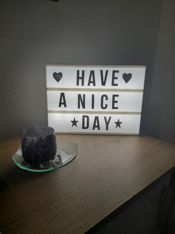 a cake on a table with a have a nice day sign at Studio Apartments Adian in Korenica