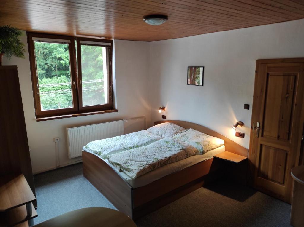 Postel nebo postele na pokoji v ubytování Apartmány Vranov