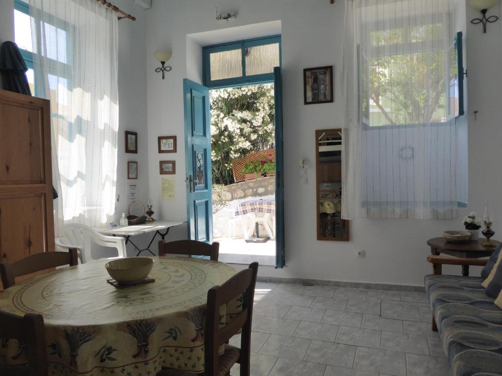 a dining room with a table and a window at Halki Townhouse in Halki