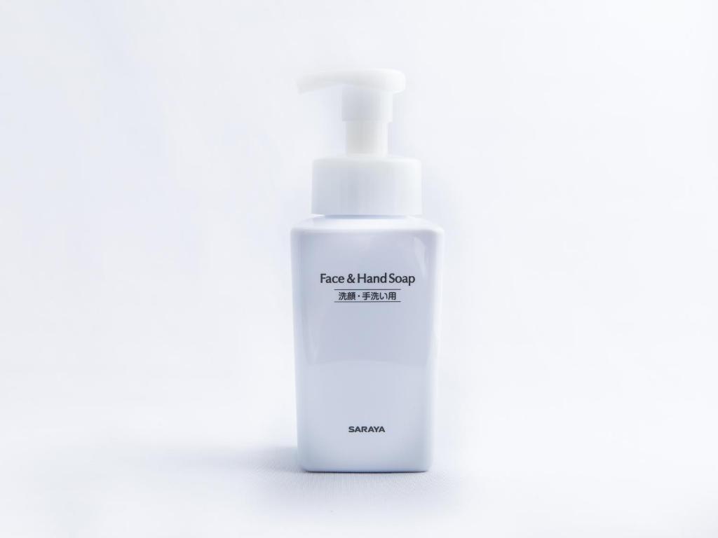 a white bottle of moisturizing soap on a white background at APA Hotel Haneda Anamori Inari Ekimae in Tokyo