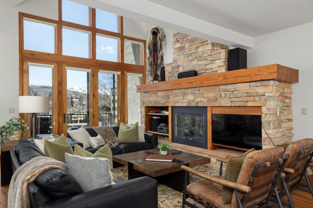 a living room with a couch and a fireplace at Aspen Ridge 9 in Telluride