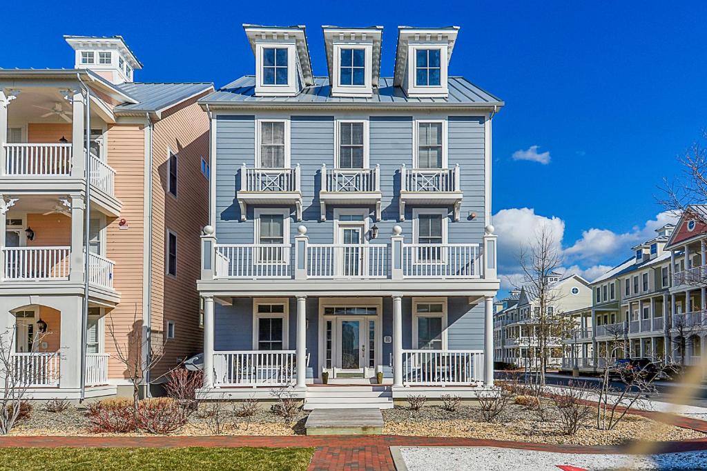 a large house with white balconies on a street at Sunset Island - Beachside Mews 1 & 2 in Ocean City