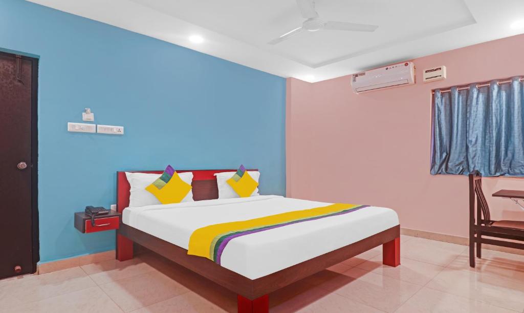 a bedroom with a bed with a blue wall at Itsy By Treebo - Aflah in Hyderabad