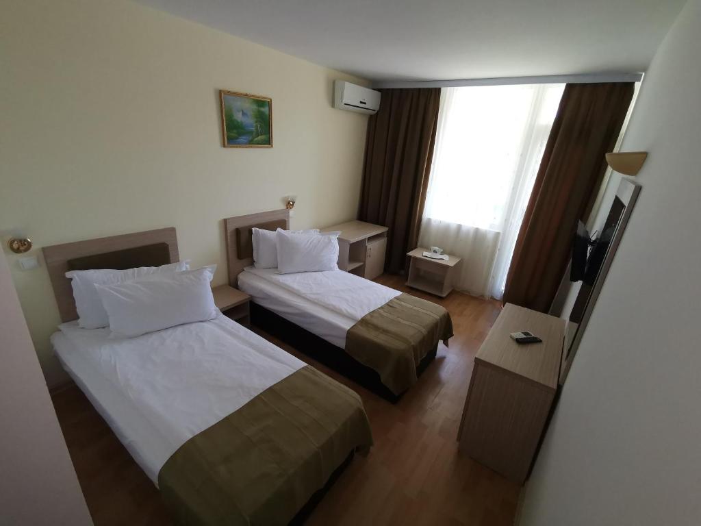 Postel nebo postele na pokoji v ubytování Hotel Apollo
