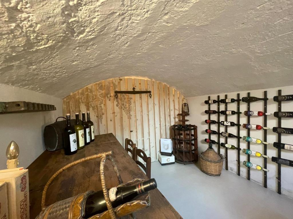 a room with a bunch of wine bottles on a wall at CORTE LARGO LAURO DIMORE & SPA in Gemini