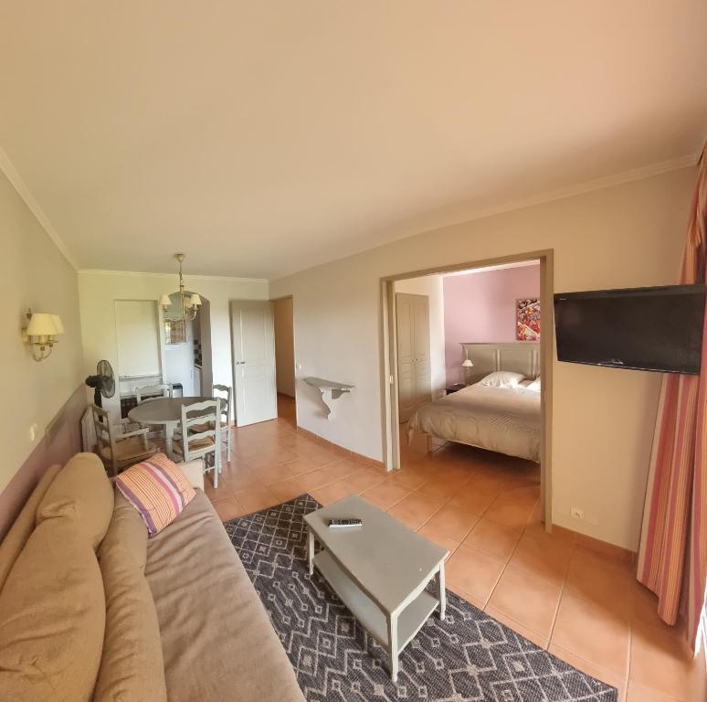 salon z kanapą i łóżkiem w obiekcie Hôtel du Golf de Pont Royal - appartement paisible rez de jardin - terrasse & piscine w mieście Mallemort