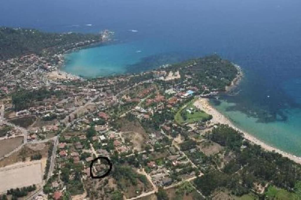 an aerial view of a city and a body of water at Arbatax, 200 metres from the beach: Apartment in villa with garden, 2 bedrooms in Àrbatax