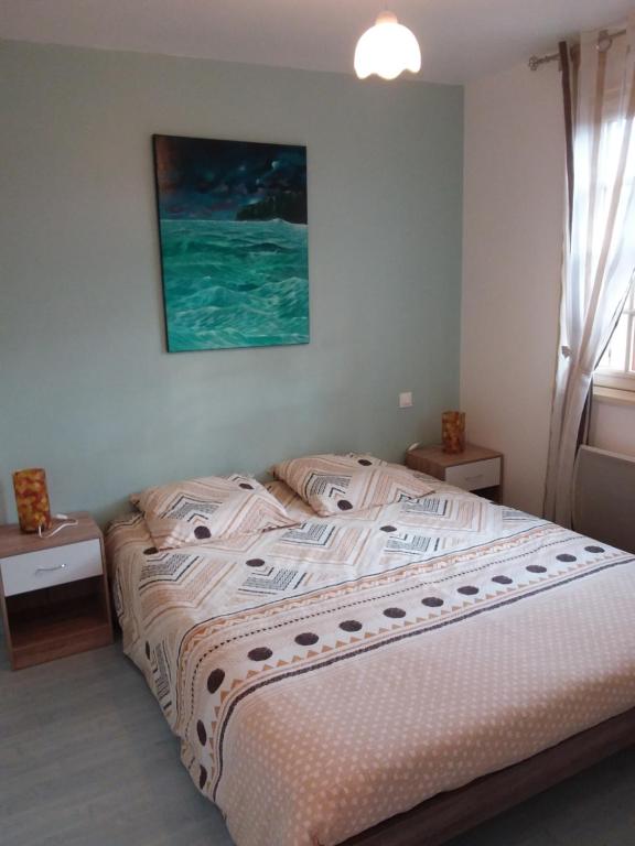 ein Schlafzimmer mit einem Bett und einem Wandgemälde in der Unterkunft Gite des artistes in Changy